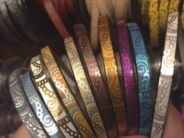 Different combinations of leather strip engraved with waves of 5x2 mm.